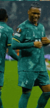 a soccer player wearing a green jersey with aia written on it