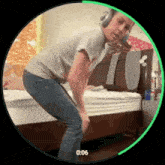 a person wearing headphones is dancing in front of a bed with a green circle around them that says 0:06