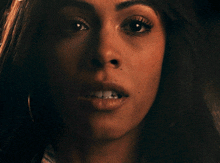 a close up of a woman 's face showing her teeth