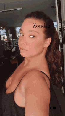 a woman taking a selfie with the word zondag written on her face