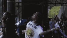a man in a white shirt is splashing water on himself