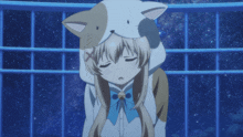 a girl wearing a cat hooded jacket with a blue bow