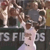 a baseball player with the number 4 on his jersey runs towards the crowd