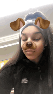 a girl wearing a black jacket with the north face on the front
