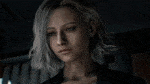 a close up of a woman 's face with a dark background