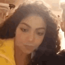 a close up of a woman 's face with a man behind her .