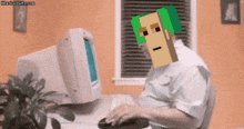 a man with a green hat on his head is typing on a computer