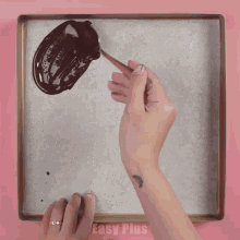 a person is spreading chocolate on a tray with easy plus written on the bottom right