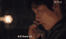 a man talking on a phone with netflix written on the bottom