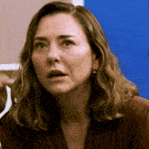 a close up of a woman 's face with her mouth open