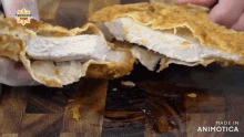 a person is holding a piece of fried food with the words made in animotica on the bottom