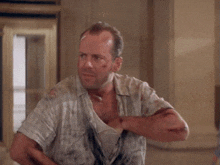 a man with a bandage on his head and the name john mcclane on the bottom