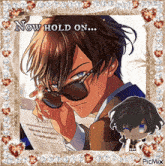 a picture of a man in sunglasses with the words now hold on