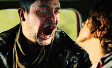a man with his mouth open is being kissed by another man