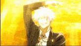a man in a suit and tie is smiling with his arm up in the air