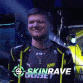 a man wearing a black shirt with the word skin rave on it