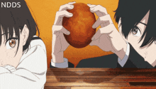 a boy and a girl are looking at a food item with ndds on the bottom right