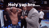 a man in a suit is talking to a fighter in a ring .