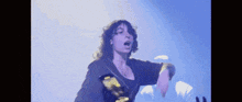 a woman is dancing on stage in front of a crowd .