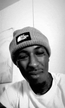 a man wearing a north face beanie looks at the camera