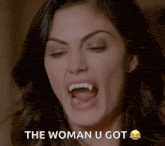 a woman with vampire teeth is screaming with the words the woman u got below her