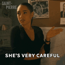 a woman says she 's very careful while standing in front of a board