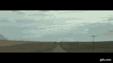 a car is driving down a road in the middle of nowhere .