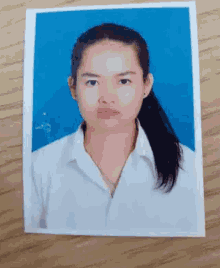a picture of a woman with long hair is on a wooden table
