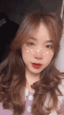 a girl with flowers on her face is wearing a purple top