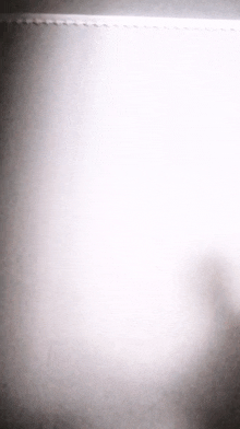 a white background with a shadow of a person on it .