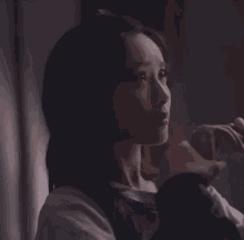 a close up of a woman 's face looking out a window .