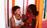 a man and a woman are standing next to each other