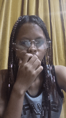 a girl with braids wearing glasses and a shirt that says eagles