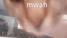 a close up of a person 's mouth with the word mwah written on it