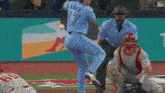 a baseball player wearing a blue jersey with the number 17 on it