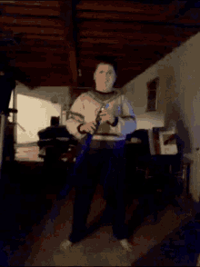 a blurry picture of a man playing a guitar with a blue light behind him