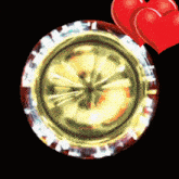 a red heart is next to a gold circle on a black background