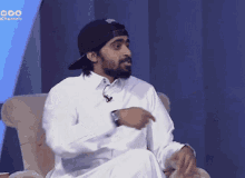 a man sitting in a chair wearing a hat with the word channels on the bottom