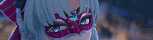 a close up of a woman wearing a red mask