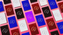 many different colored gv cards are lined up on a pink background