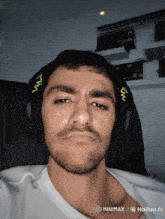 a man wearing headphones is taking a selfie with the hashtag minimaxi