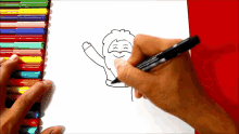 a person is drawing a picture of santa claus with a marker