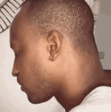 a close up of a man 's face with his eyes closed and his head turned to the side .