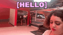 a woman is standing in front of a sign that says [ hello ]