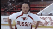 a man wearing a russian jersey is standing on the ice .