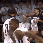 a group of basketball players are standing next to each other on a court .