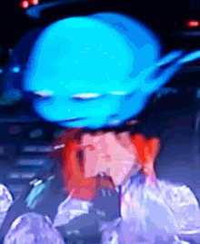 a blurry picture of a person with a blue head on their head