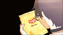 a person holding a bag of lay 's chips