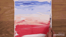 a red white and blue painting with the words made in animotica on the bottom