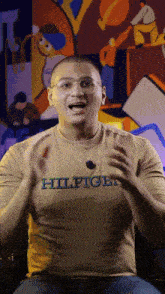 a man wearing a t-shirt that says hilfiger